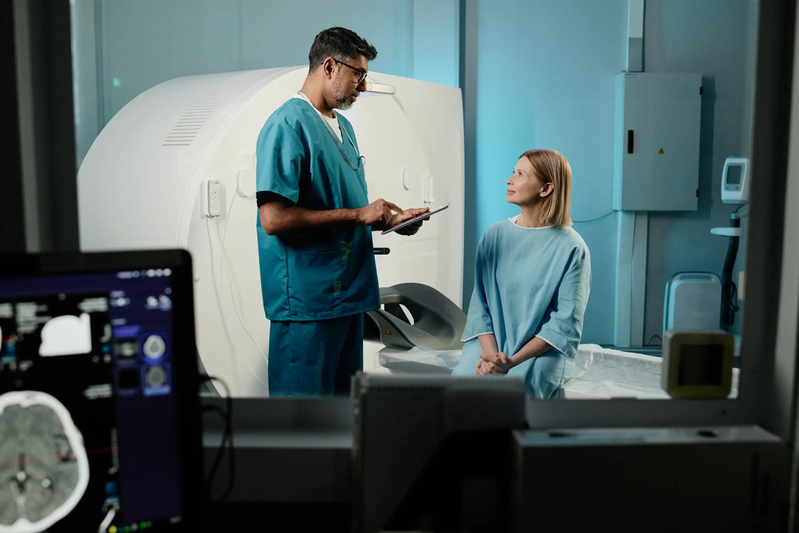 Radiographer operating imaging equipment