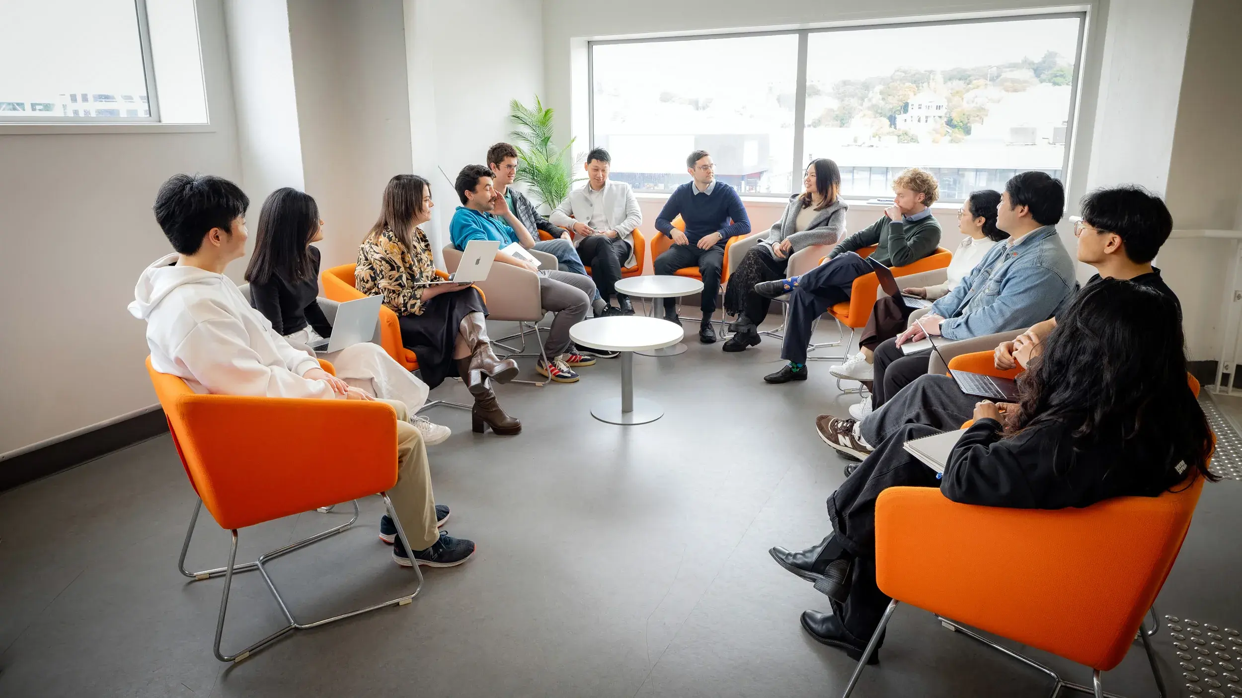 The RosterLab team in a group discussion in the office