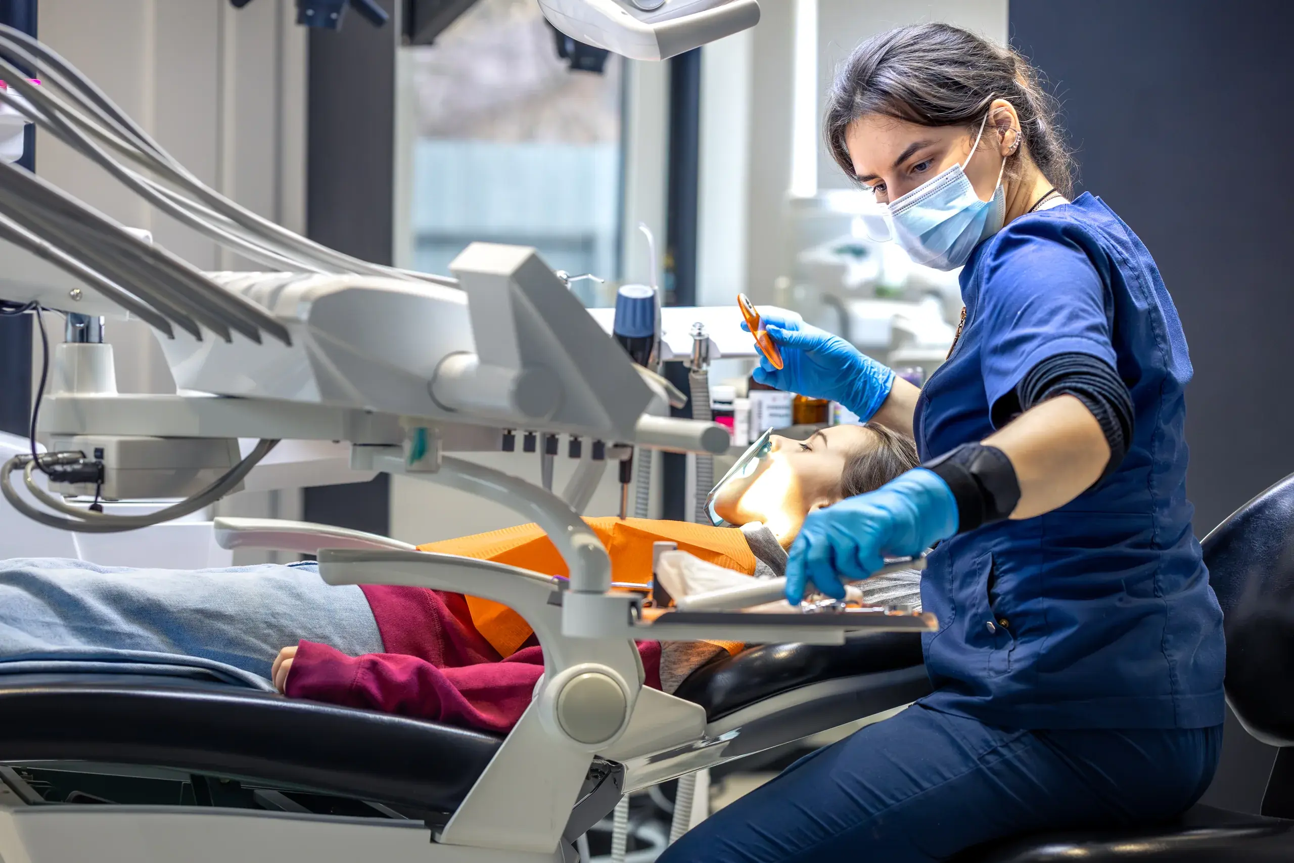 Dentist treating a patient in a dental chair