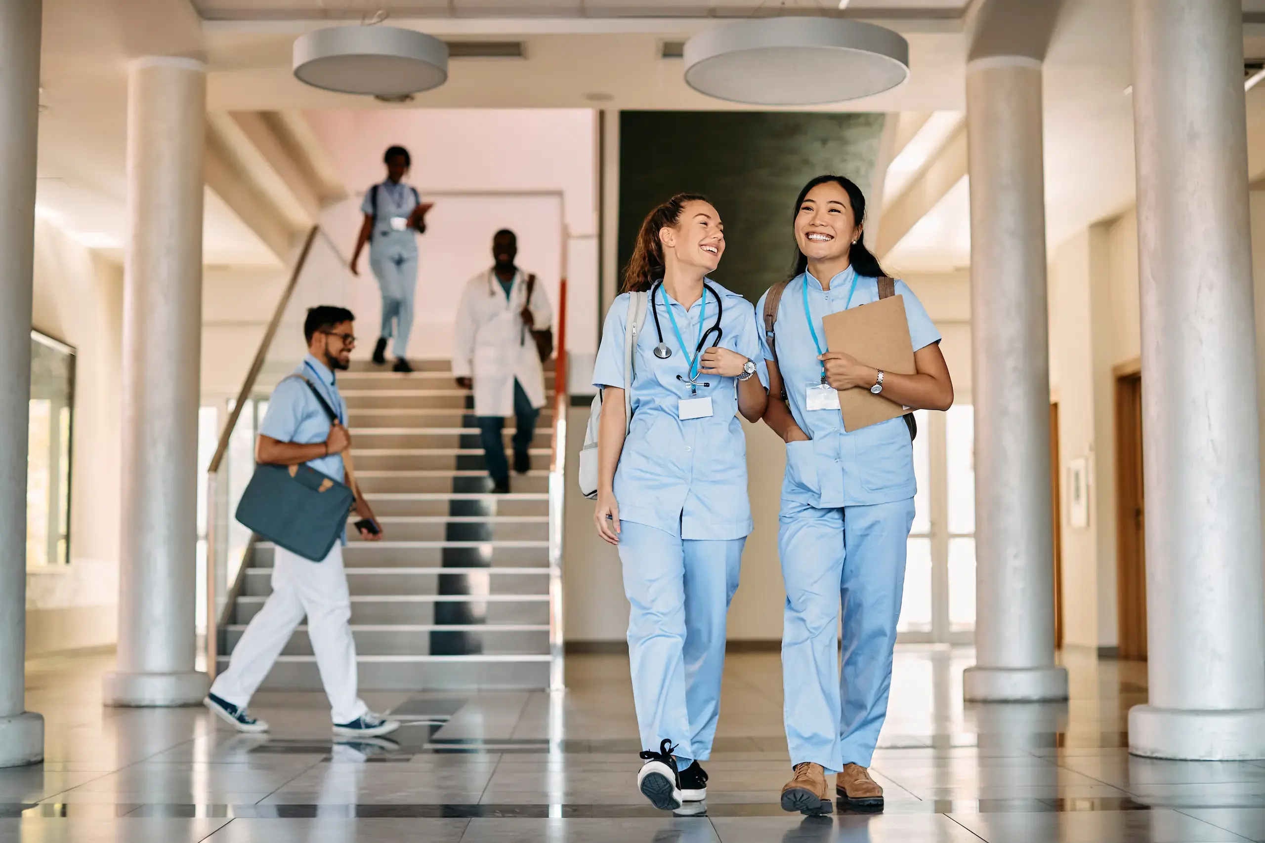 Healthcare staff walking through a hospital corridor