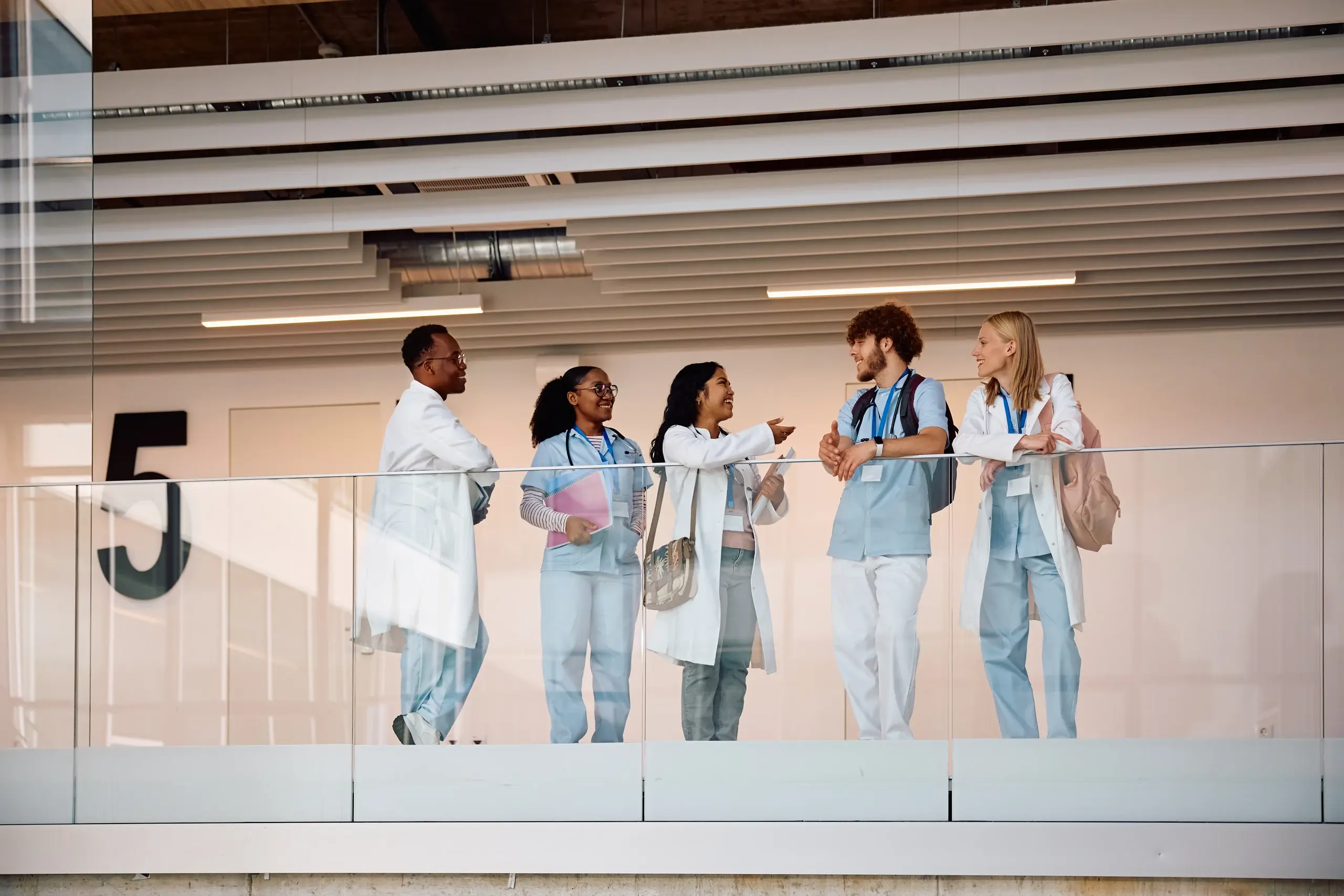Clinical team talking together on a hospital walkway