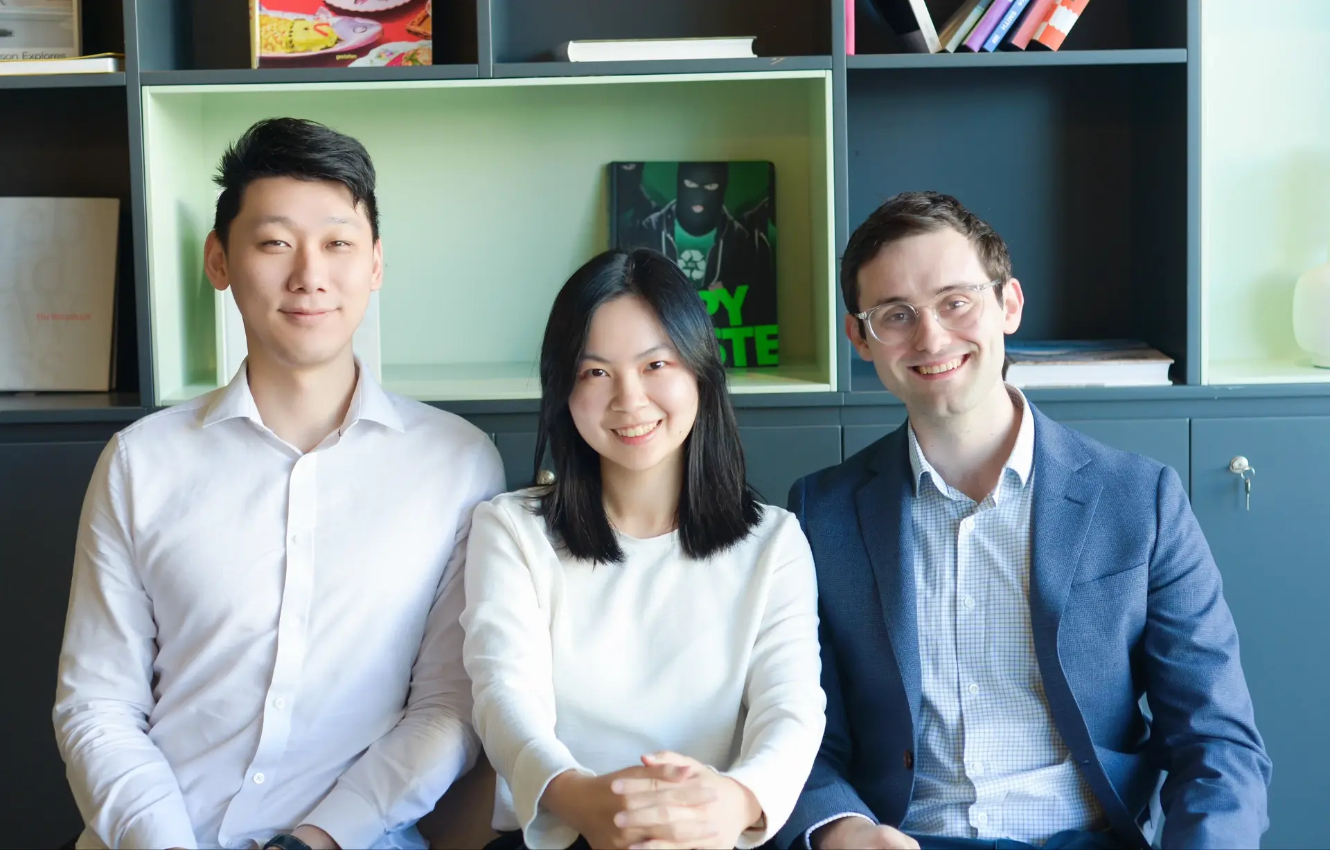 The three RosterLab founders seated together in the office