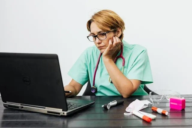 schedule maker at laptop nurse