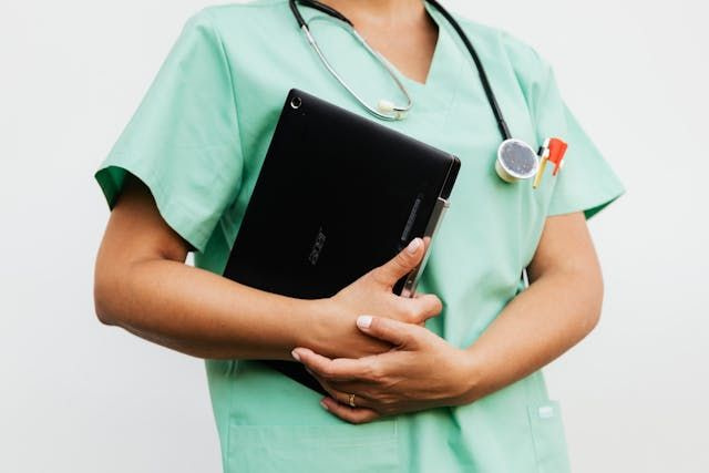 nurse shift worker carrying laptop