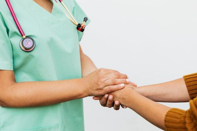 hand on patient nurse