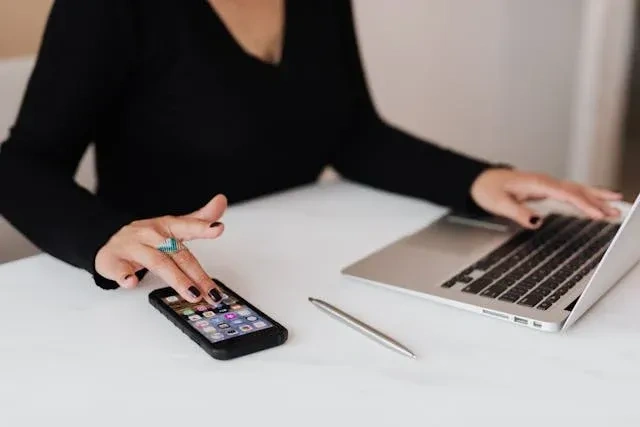 women on laptop and mobile