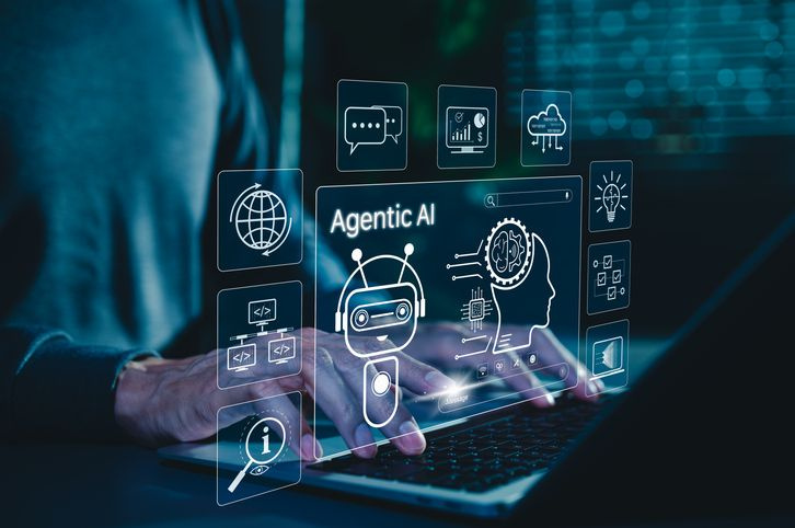 person on laptop with agentic ai graphics visible