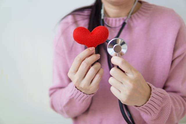 medical equipment person holding heart