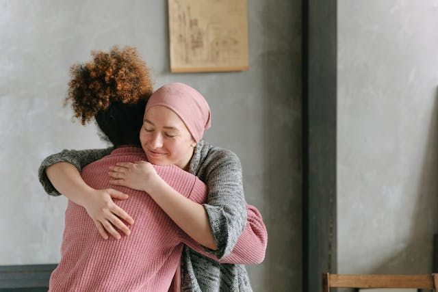 patient and carer hugging