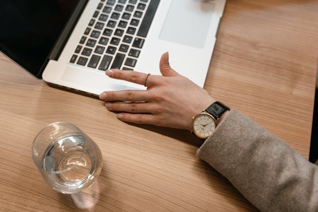 person hands on laptop