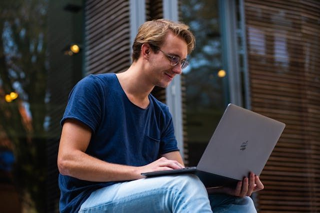 person on laptop smiling