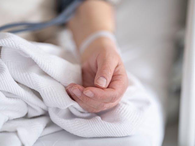persons hand in hospital bed