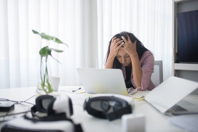 women at laptop stressed doing payroll
